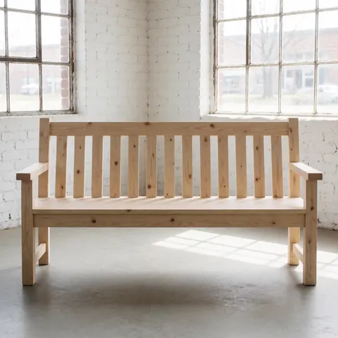 Un banc en bois clair avec des nœuds visibles, placé dans un atelier aux murs de briques blanches et à grandes fenêtres laissant entrer la lumière naturelle.