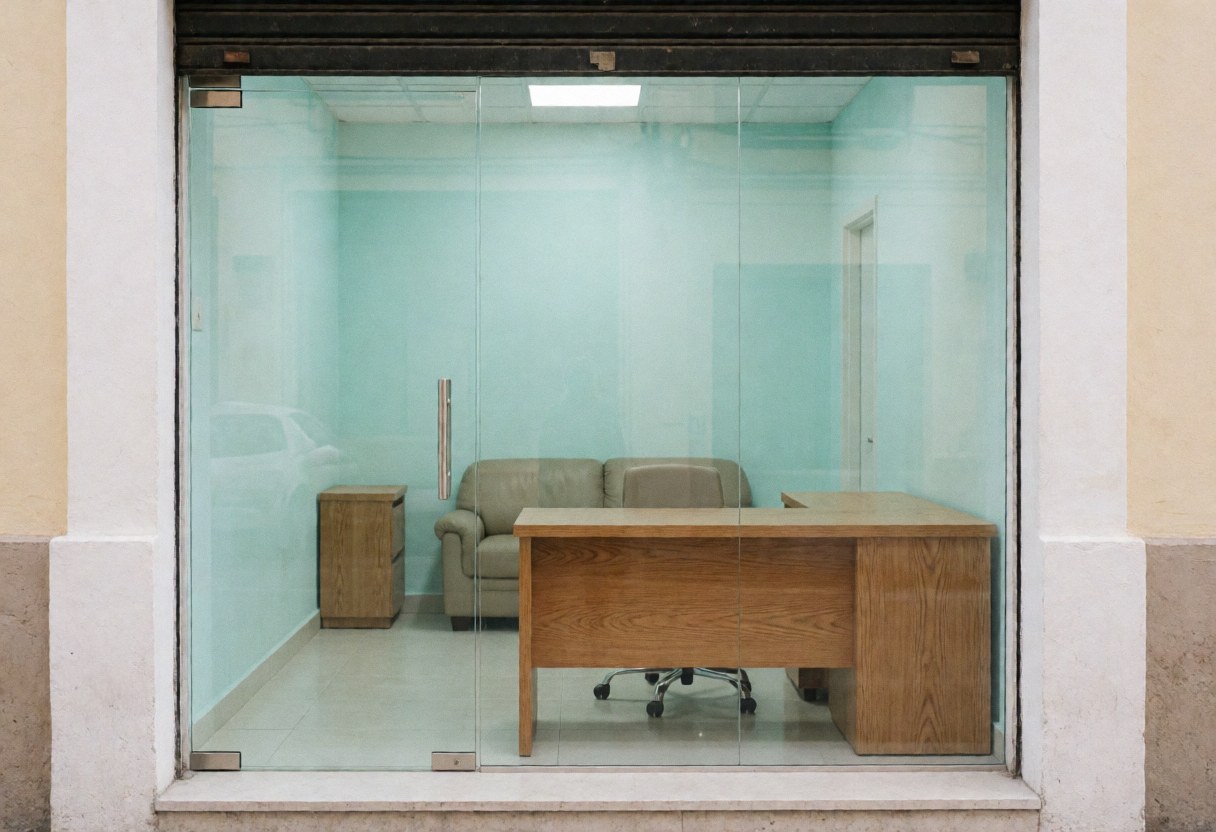 Vue depuis la rue d'un bureau de sécurité moderne avec un bureau en chêne, un canapé et des murs turquoise, offrant une ambiance professionnelle et épurée.