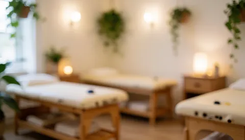 Arrière-plan d'une salle de reflexologie avec lits en bois, plantes suspendues et éclairage chaleureux, idéal pour textes ou logos.