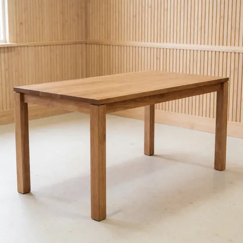 Table en bois massif avec finition soignée, vue de dessus sur fond blanc, mettant en valeur le grain naturel du bois et la qualité du travail de menuiserie.