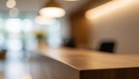 Arrière-plan abstrait d'accueil en bois aux tons chauds, flou artistique idéal pour insérer du texte, ambiance professionnelle et accueillante sans personnes ni logos visibles.