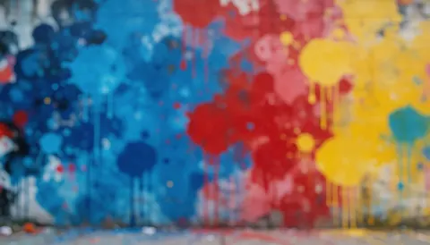 Fond de mur urbain avec taches de peinture bleue, rouge et jaune, idéal pour textes, avec profondeur de champ réduite et lumière douce.