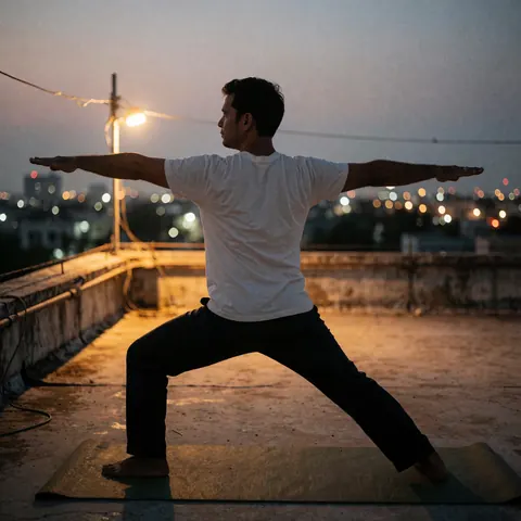 Un homme pratique le yoga en posture de guerrier sur une natte au coucher du soleil avec des lumières urbaines floues en arrière-plan.