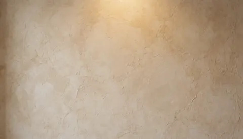 Mur beige en stuc rustique offrant une texture naturelle et chaleureuse, servant de fond neutre idéal pour l'intégration de textes commerciaux ou de contenus graphiques.