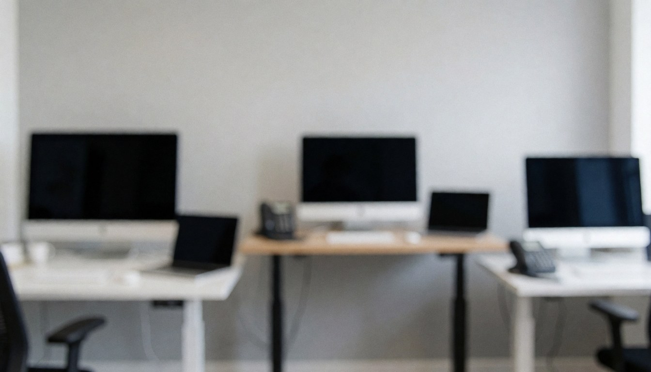 Arrière-plan de studio avec moniteurs, bureaux et chaises de bureau, idéal pour textes corporatifs.